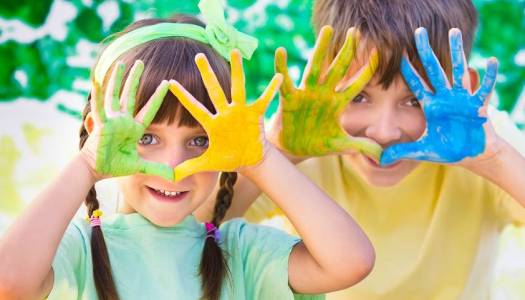 Two children with paint covered hands - keep your home tidy